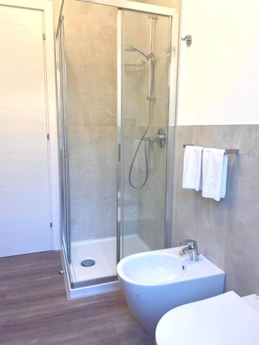 a bathroom with a shower and a sink and a toilet at Guest Martilla Luxury & Garden in Garda