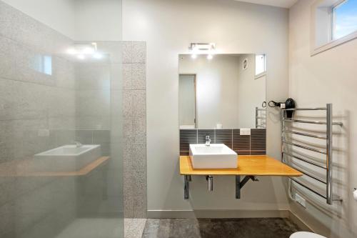 a bathroom with a sink and a mirror at Five Mile Bliss - Lake Taupo Holiday Home in Waitahanui