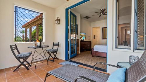 a room with a bed and a table and chairs at LV025 Airy Upstairs Studio with Mountain Views in La Quinta