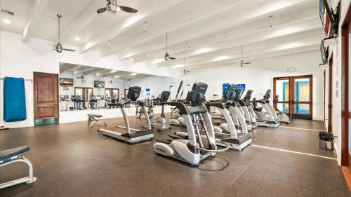 a gym with rows of treadmills and elliptical machines at LV025 Airy Upstairs Studio with Mountain Views in La Quinta
