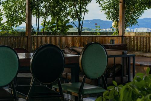 a table and chairs sitting in front of a fence at 张家界天门山伴田居民宿 in Zhangjiajie