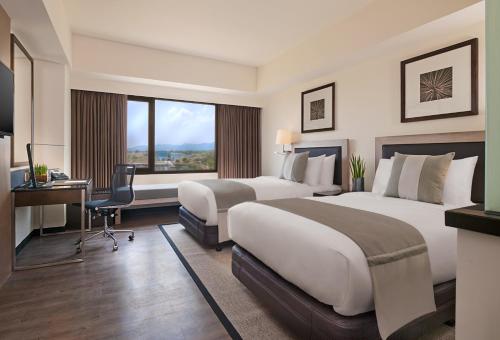 Una cama o camas en una habitación de Seda Nuvali