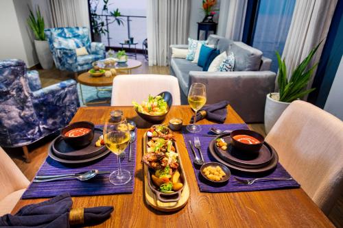 a dining table with food and wine glasses on it at MaRadha Colombo in Colombo