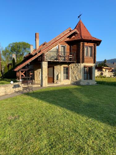 a house with a large yard in front of it at Sofiya in Mykulychyn