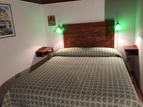 a bedroom with a large bed with two lights on it at Ghibellina 65 At Medici in Florence