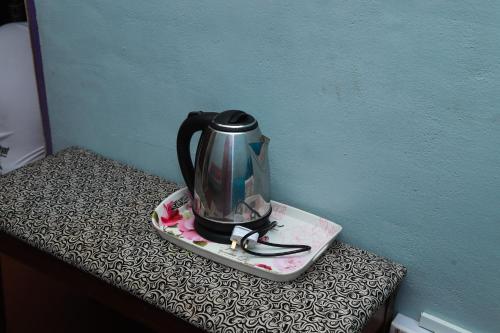 a tea kettle on a plate on a table at Villa Uda @ SIBLINGS Cottage in Setiu