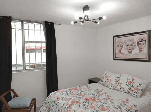 a bedroom with a bed and a ceiling fan and a window at Departamento Cerca del Aeropuerto/ Buena Ubicación in Mexico City