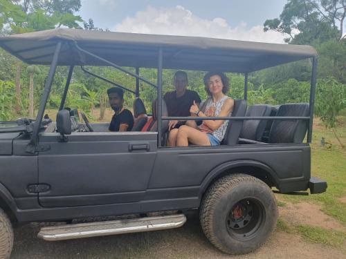 a group of three people riding in a jeep at Wilpattu homestay by Ceylon group in Wilpattu