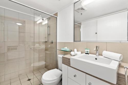 a bathroom with a sink and a toilet and a shower at Cairns Central Plaza Apartment Hotel Official in Cairns