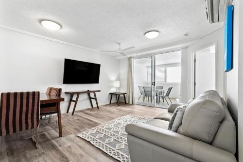 a living room with a couch and a table at Cairns Central Plaza Apartment Hotel in Cairns