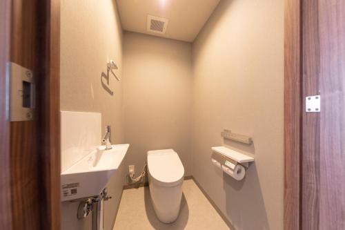 a small bathroom with a toilet and a sink at Tokyu Stay Sapporo Odori in Sapporo