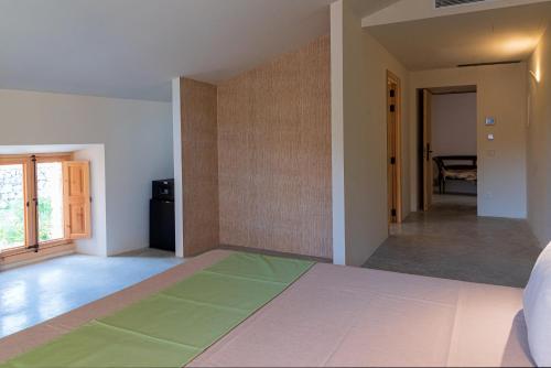 a bedroom with a large bed and a hallway at Agroturisme Subies in Selva