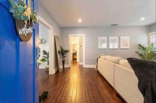 a living room with a white couch in a room at Hollywood house with parking - walk to attractions in Los Angeles