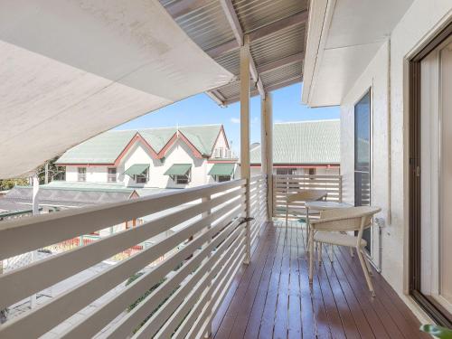 a balcony with a table and chairs on it at Montville Attic in Montville
