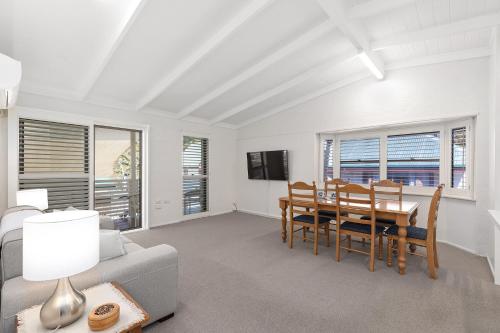 a living room with a table and a dining room at Montville Attic in Montville