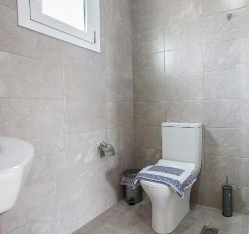 a bathroom with a toilet and a sink at heaven suite elafonisi in Elafonisi