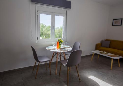 a living room with a table and chairs and a couch at heaven suite elafonisi in Elafonisi