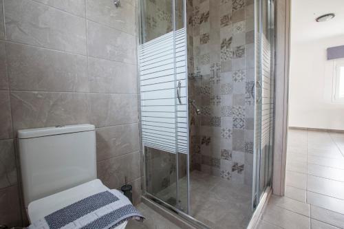 a bathroom with a toilet and a glass shower at heaven suite elafonisi in Elafonisi