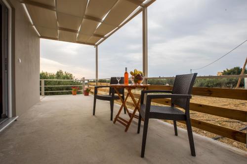 a table and chairs on a patio with a view at heaven suite elafonisi in Elafonisi
