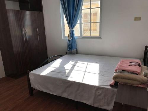 a large bed in a room with a window at RPU Wen's Villa in Dauis