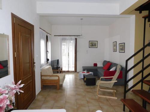 a living room with a blue couch and chairs at Villa Dima in Paleo Tsifliki
