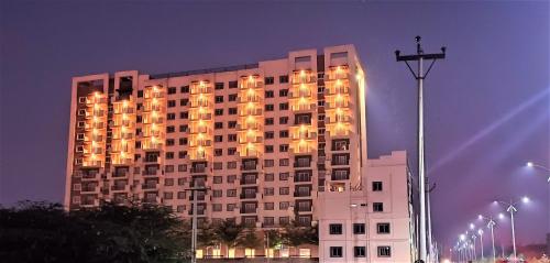 a large building with lights on it at night at Starlit Suites Tirupati LLP in Tirupati
