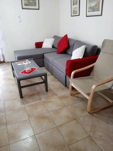 a living room with a couch and a table and chairs at Villa Dima in Paleo Tsifliki
