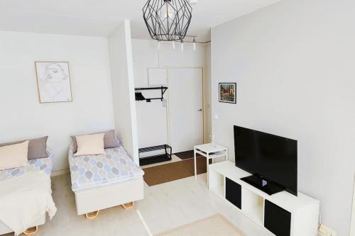 a living room with a flat screen tv and a couch at Very quiet and well located apartment in Tammela, Tampere in Tampere