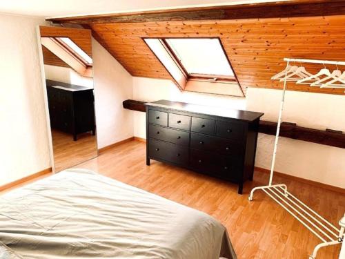 a bedroom with a bed and a dresser with a window at Apartment Romanshorn von Swisspartments in Romanshorn