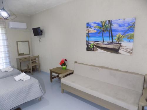a room with two beds and a painting on the wall at Afrodite Spacious Apartments! in Agia Effimia