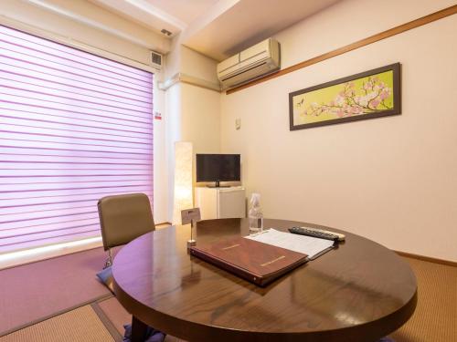 an office with a wooden table and a chair at Omotenashi Hostel Miyajima in Hatsukaichi