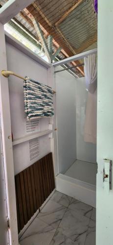 a walk in closet with a towel hanging on the wall at Meyenburg Glamping in Mount Morgan