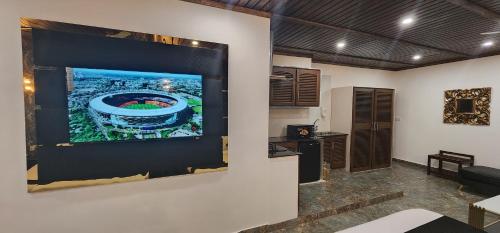 a large flat screen tv hanging on a wall at Lawrence View Hotel, Lahore in Lahore