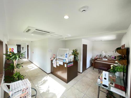 an office with a reception desk and a piano at Ao Hotel in Nago