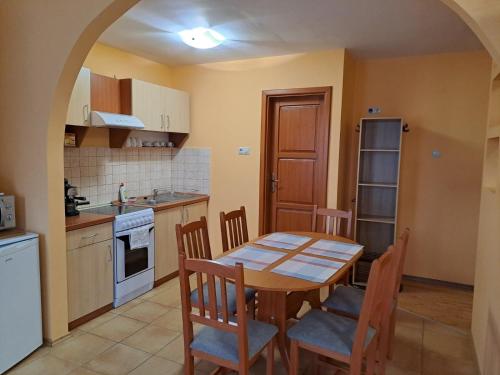 A kitchen or kitchenette at Rozmaring Apartmanok