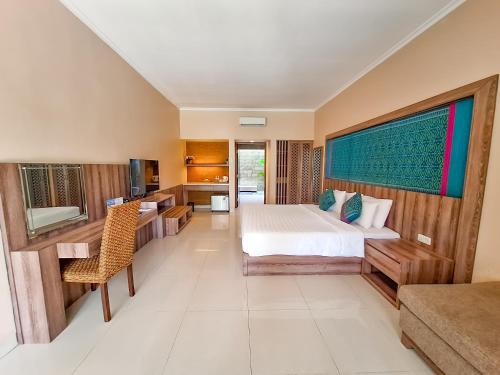 a hotel room with a bed and a desk at Sekuro Village Beach Resort in Jepara