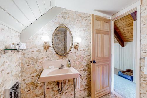 a bathroom with a sink and a mirror on the wall at Mad River Valley Ski Chalet in Waitsfield