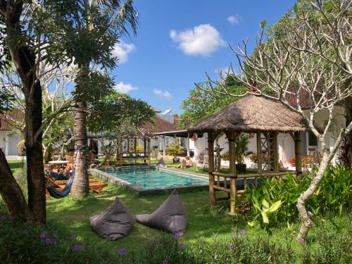 a resort with a swimming pool and a gazebo at Rebels Point in Jimbaran