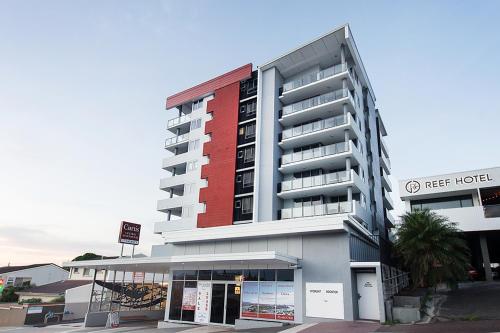 a hotel with a red and white building at Curtis Central Apartments Official in Gladstone