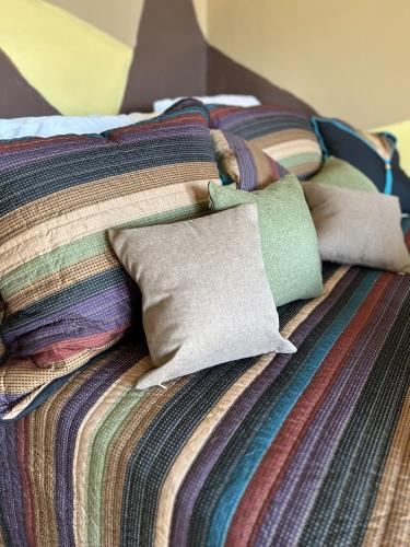 a bed with colorful sheets and pillows on it at Area 3251 Desert Valley Guest Suite in Pahrump