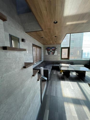 a living room with a couch and a table at 葉山THE TERRACE HOUSE in Hayama