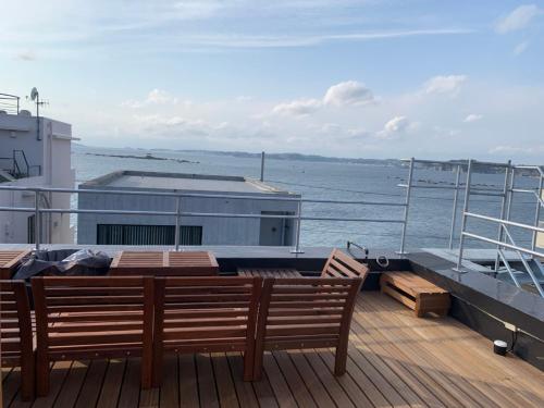 a deck with two wooden benches on a boat at 葉山THE TERRACE HOUSE in Hayama
