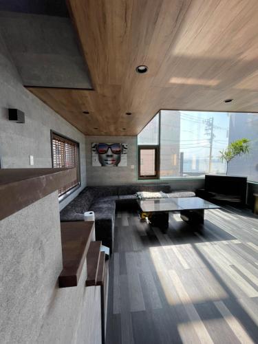 a living room with a couch and a table at 葉山THE TERRACE HOUSE in Hayama