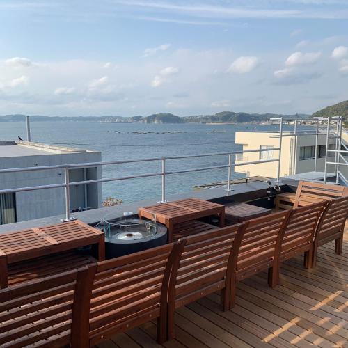 a deck with benches and a grill on a boat at 葉山THE TERRACE HOUSE in Hayama