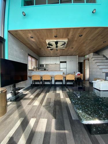 an open living room with a table and chairs at 葉山THE TERRACE HOUSE in Hayama