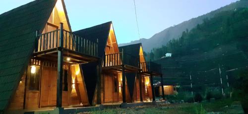 a building with two balconies on the side of it at Cabin LEHA LEHE SYARIAH Dieng in Diyeng