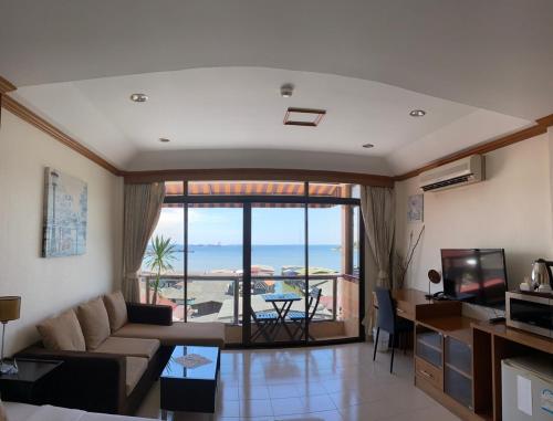 a living room with a view of the ocean at Seaview Sriracha Hotel in Si Racha