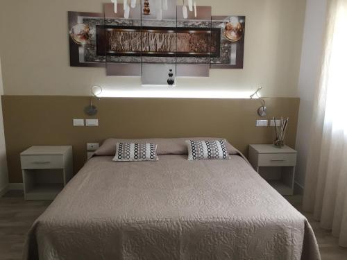 a bedroom with a bed with two pillows on it at Flyingaway in Borso del Grappa