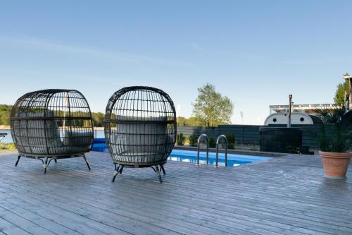 two bird cages sitting next to a swimming pool at Villa Sirena Apartments in Pärnu