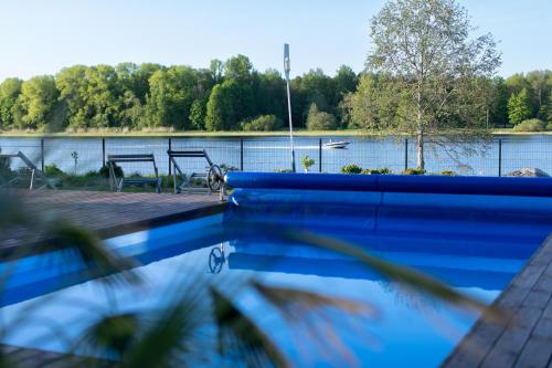 a swimming pool with a view of a lake at Villa Sirena Apartments in Pärnu